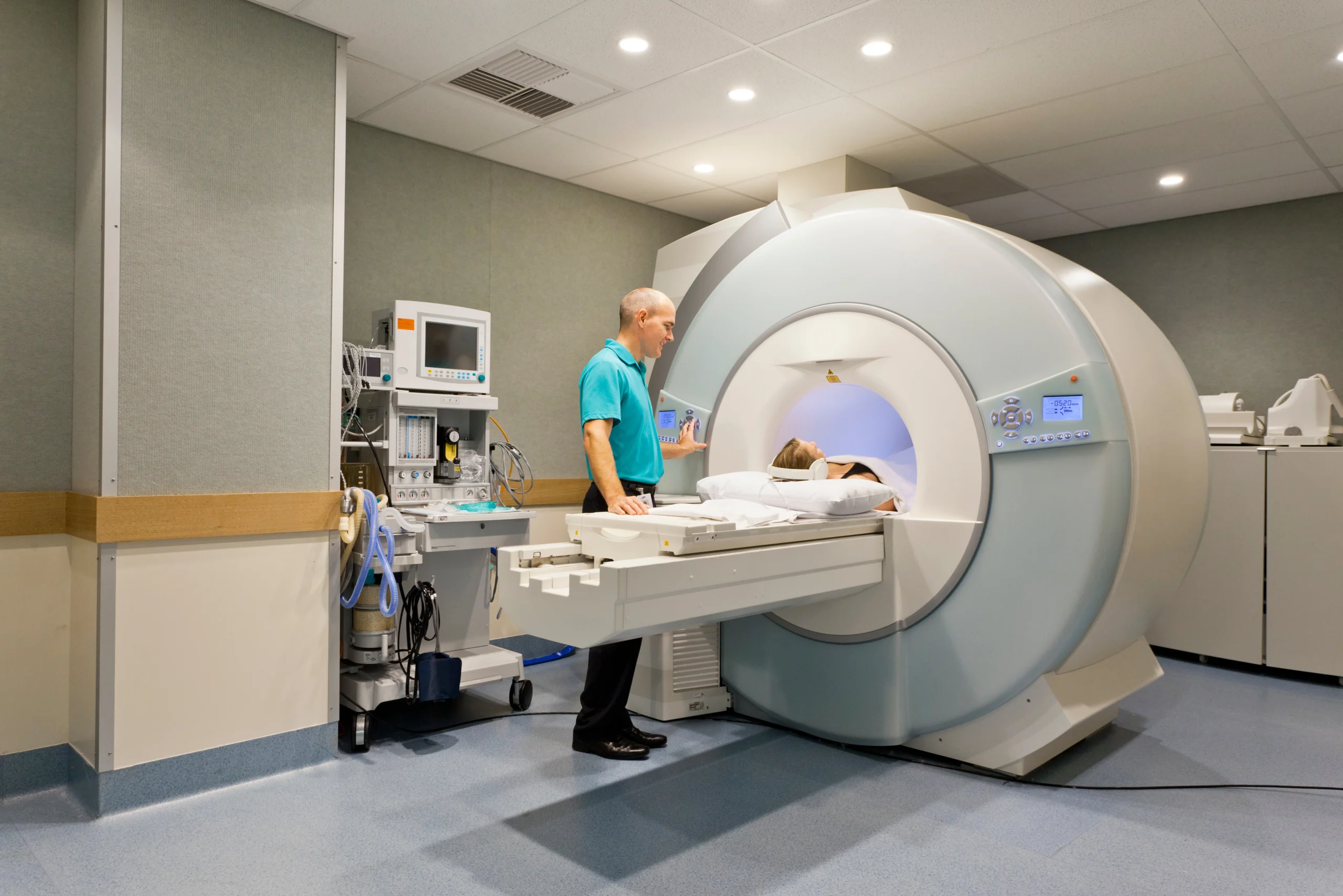 tech with MRI patient with headphones